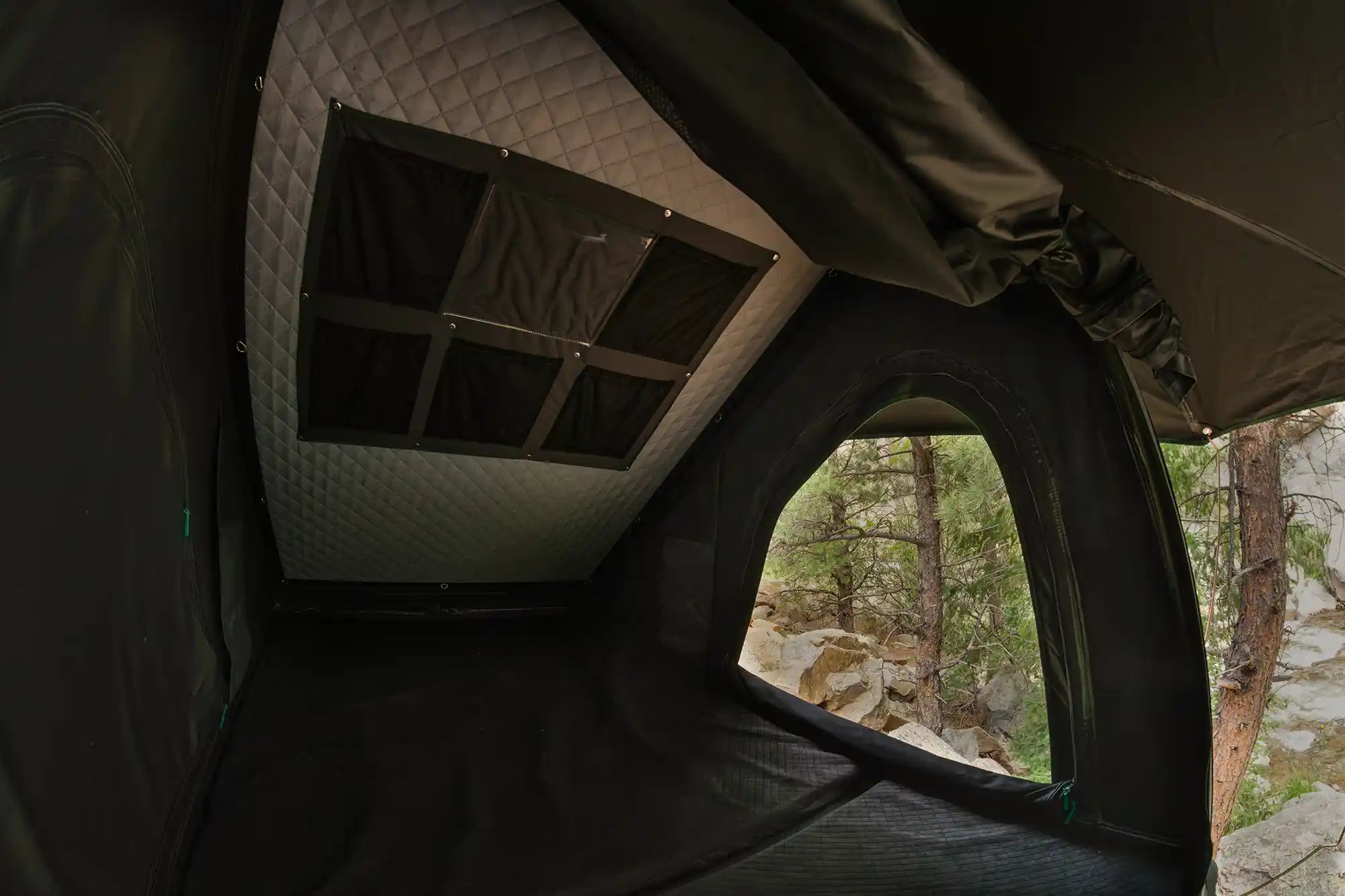 Inside a wedge roof top tent with internal storage pockets