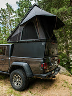 Jeep Gladiator truck bed camper with roof top tent in forest