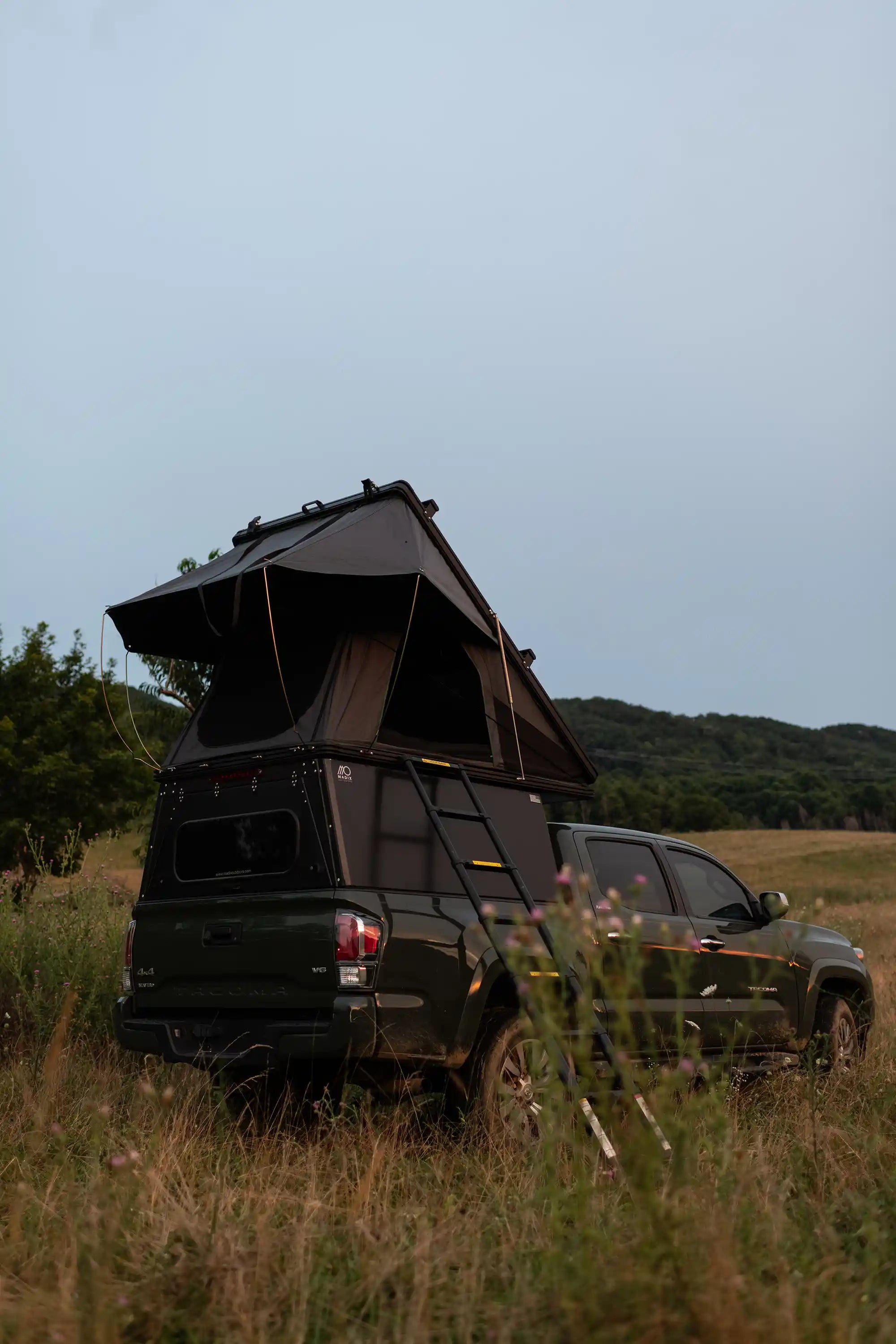 Toyota Tacoma with aluminum truck camper shell and rooftop tent