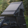 Toyota Tacoma with Truck Bed Camper and Rooftop Tent in the Forest