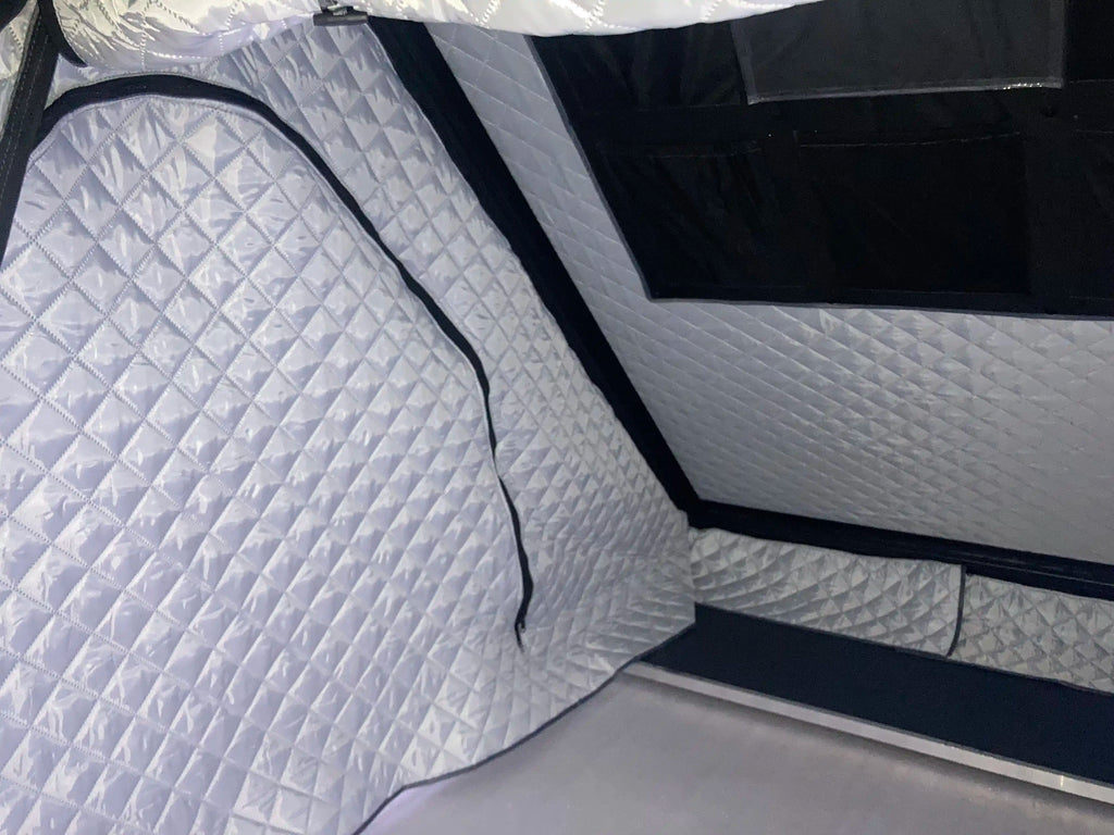 Quilted gray thermal liner inside rooftop tent.