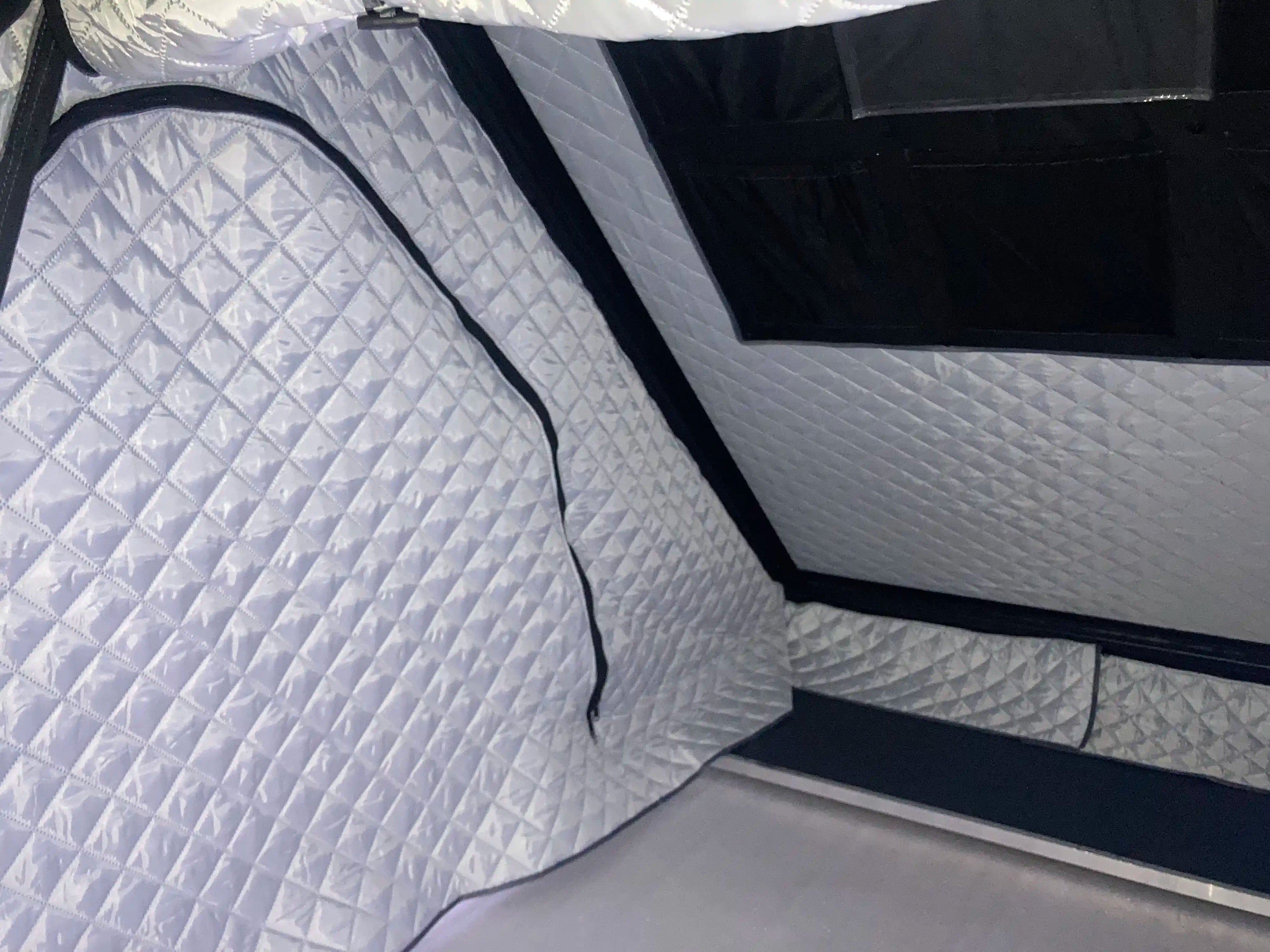 Quilted gray thermal liner inside rooftop tent.